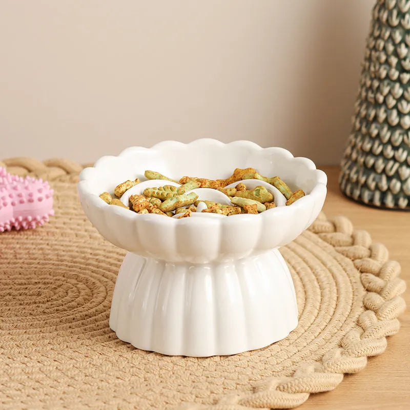 Ceramic slow feed dish with flower pool design and higher edges for cats and small dogs, shown in pink.