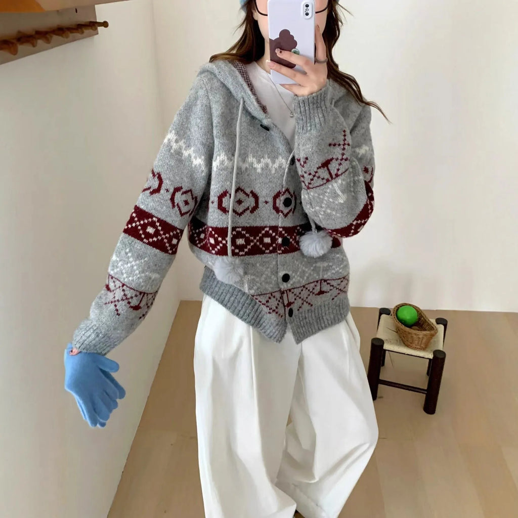 Plus size loose grey acrylic sweater coat with white geometric brocade pattern.