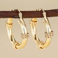 Geometric women's copper earrings with ring and line elements in golden colour