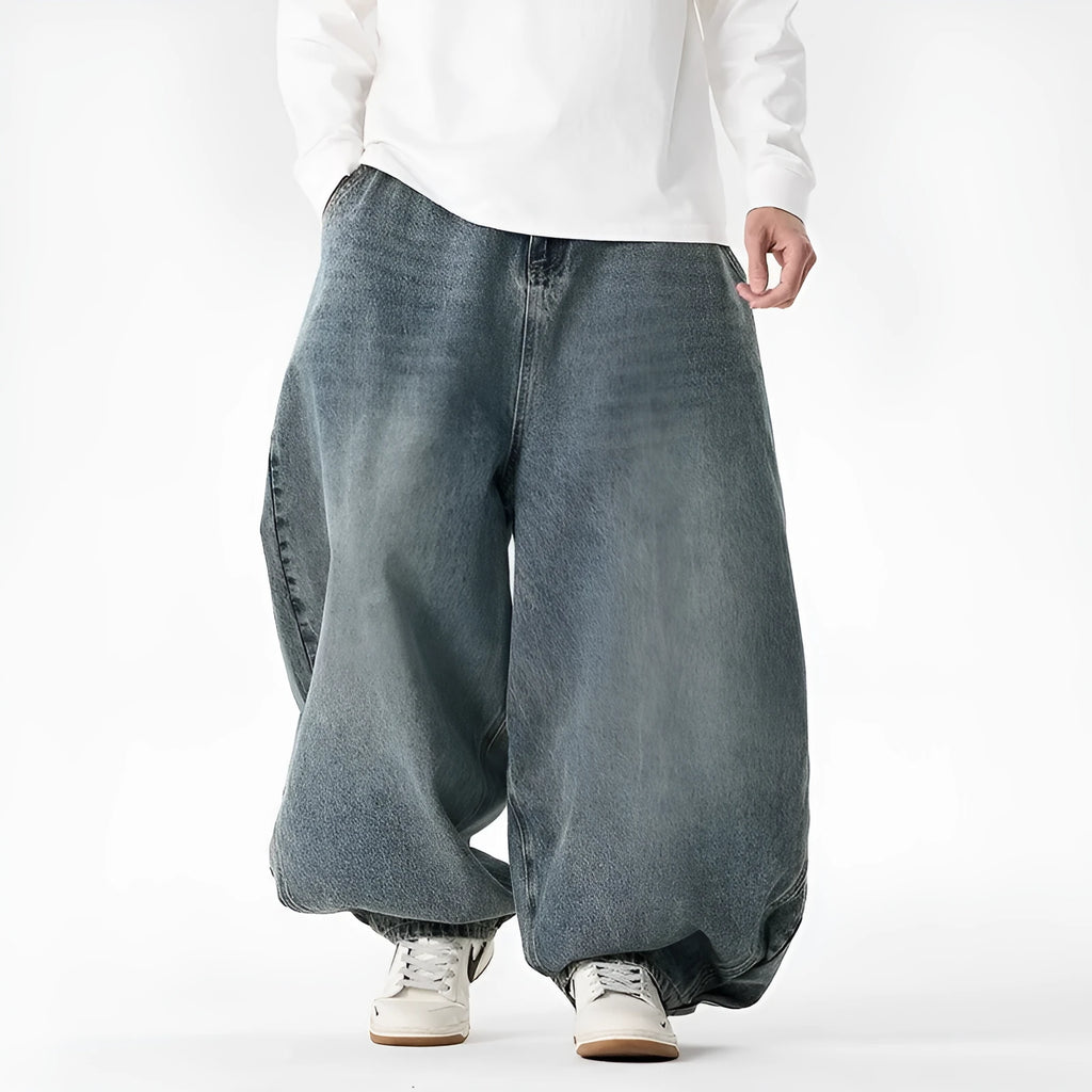 Man wearing plus size light blue wide leg baggy jeans, low waist straight leg casual style.