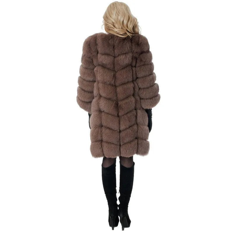 A woman wearing a long black artificial fur coat with regular sleeves.
