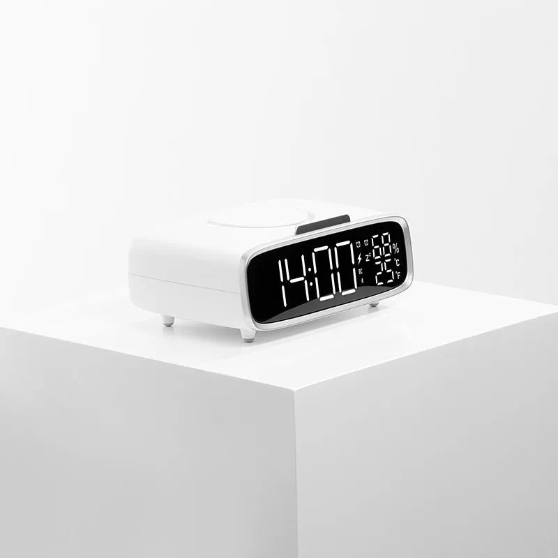 White wireless charging Bluetooth speaker alarm clock with LED night light on bedside table
