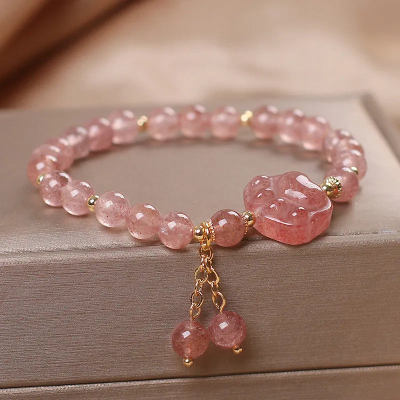 Women's double layer Strawberry Quartz crystal bracelet with Lucky Cat charm and red cat's eye flowers.