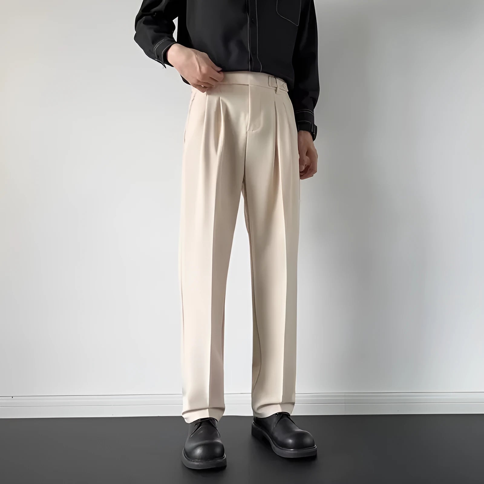 Men's apricot and black loose straight-leg suit trousers on hanger with size tags