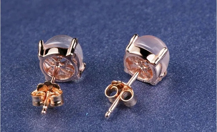 Rose gold plated drop shape stud earrings with a synthetic quartz crystal inlay detail.