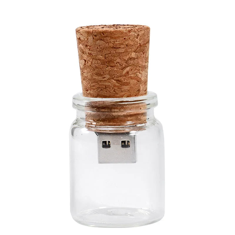 Chocolate brown wooden drift bottle shaped USB flash drive on a wooden surface.