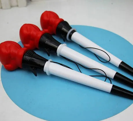 Four black boxing press ejection pens with a bullet-shaped 0.7mm tip on a desk.