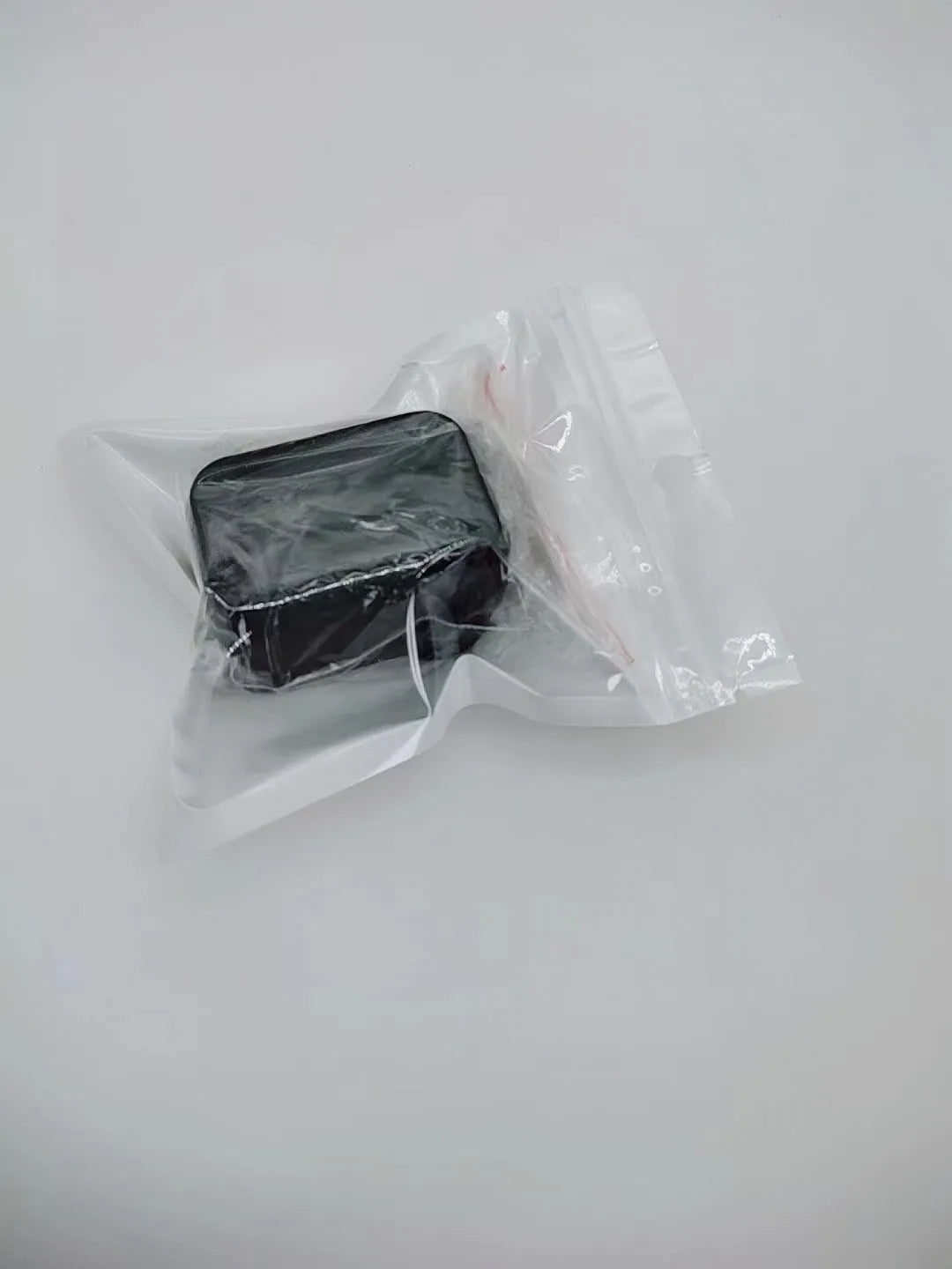 Black plastic seat belt lock catch protective device installed on automotive seat belt buckle