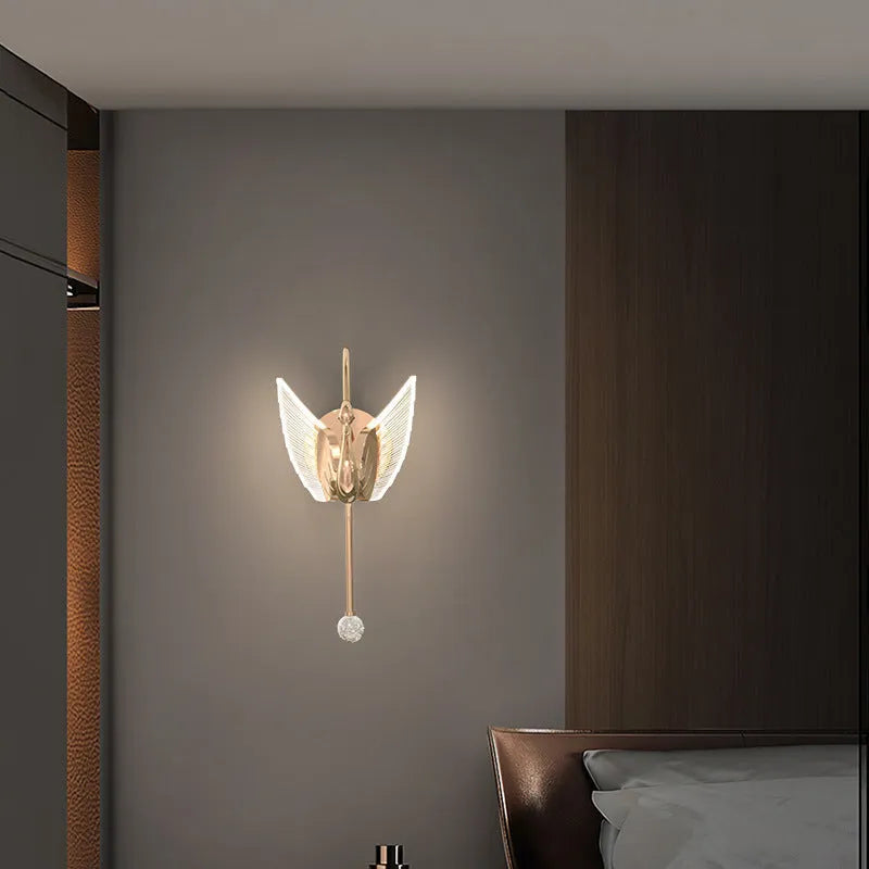 Modern minimalist gold swan-shaped LED wall lamp for bedside lighting.