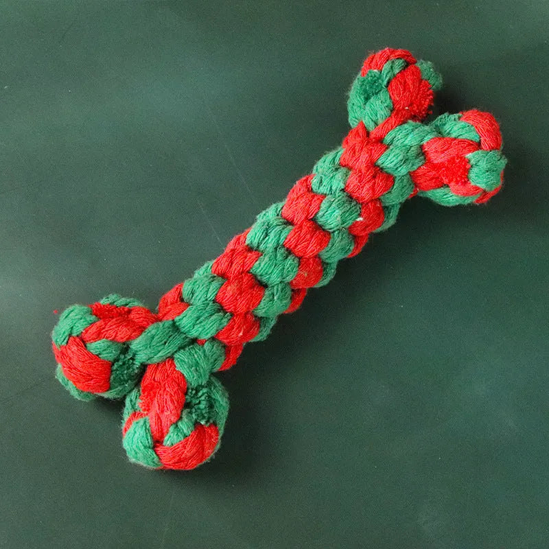 Four Christmas-themed cotton rope dog toys in red and green, including candy cane, bone, crutch, and tree shapes