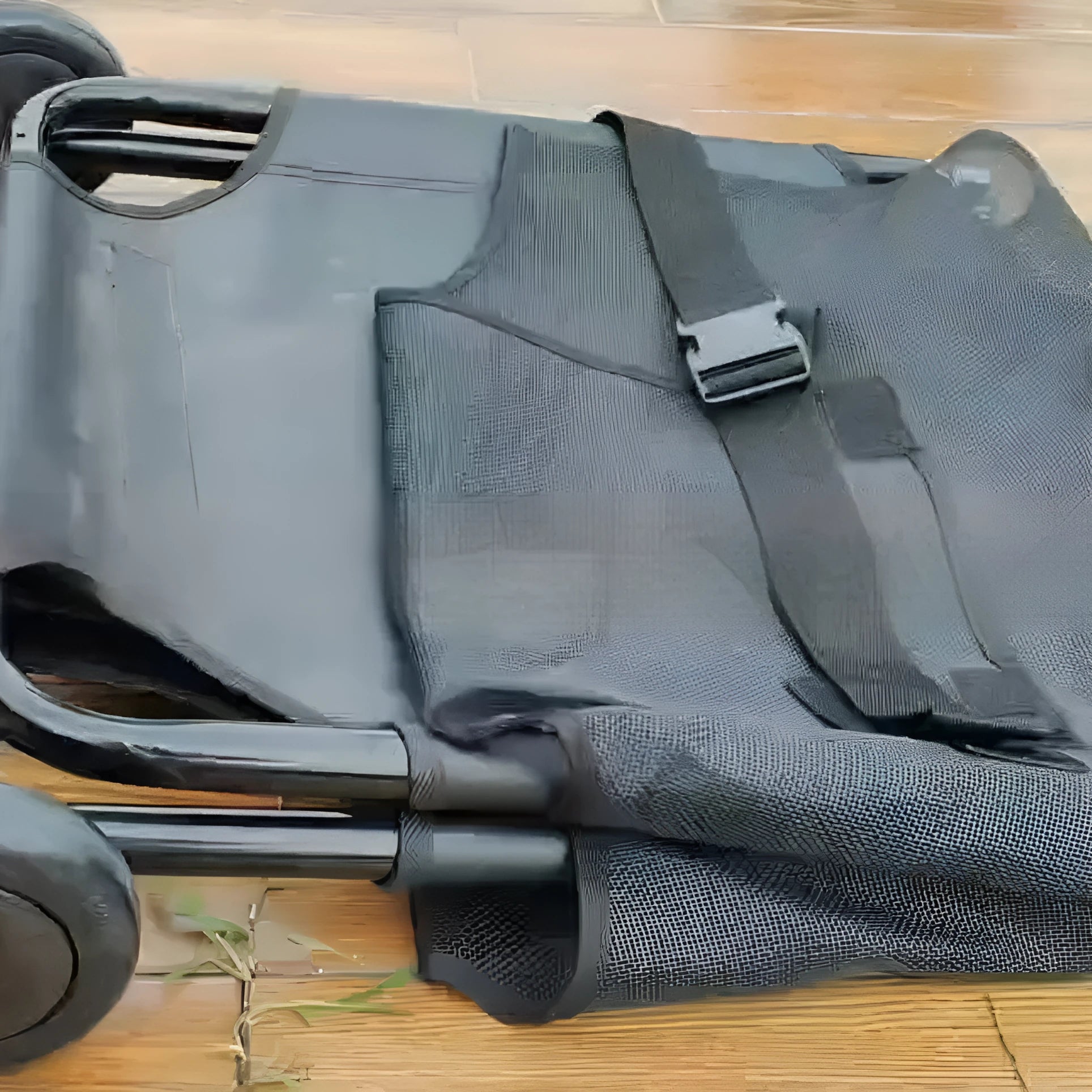 Large black folding aluminium alloy pet stretcher for emergency dog transfer.
