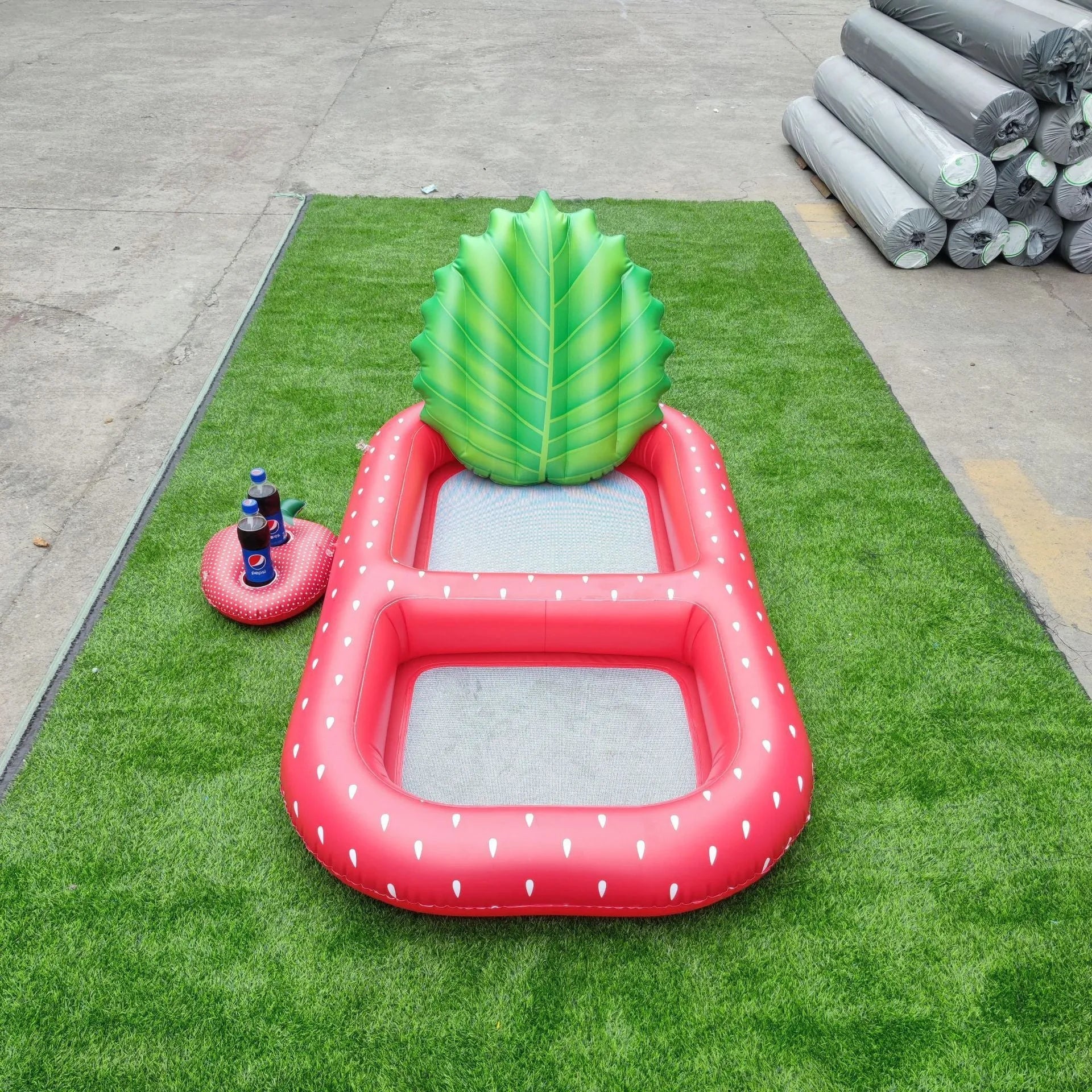 Inflatable pineapple pool lounger with cup holder floating on water in yellow colour