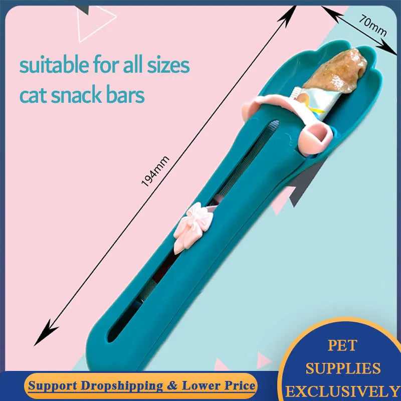 Green and pink pet food squeezer spoon for dispensing treats and liquid food to cats and dogs.