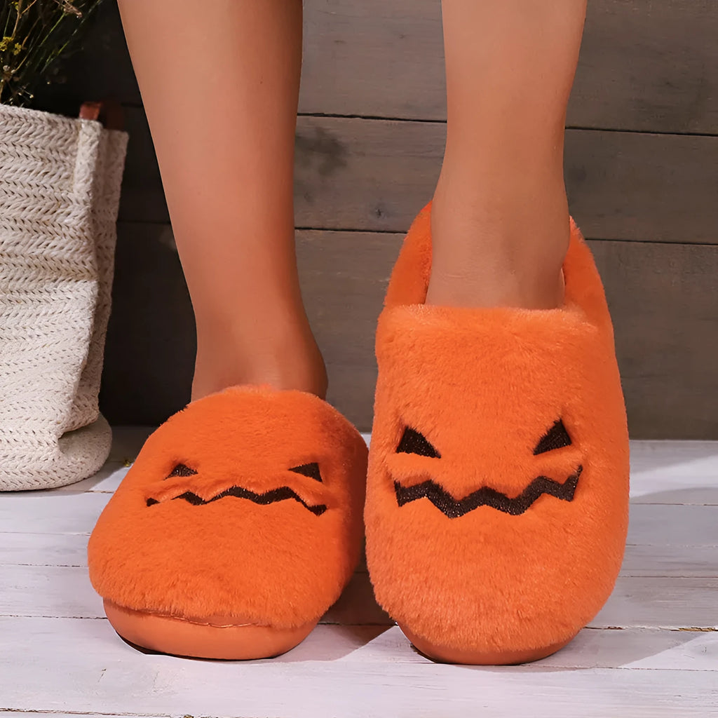 Orange Halloween pumpkin slippers with plush lining and a textured non-slip PVC sole.