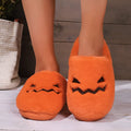 Orange Halloween pumpkin slippers with plush lining and a textured non-slip PVC sole.