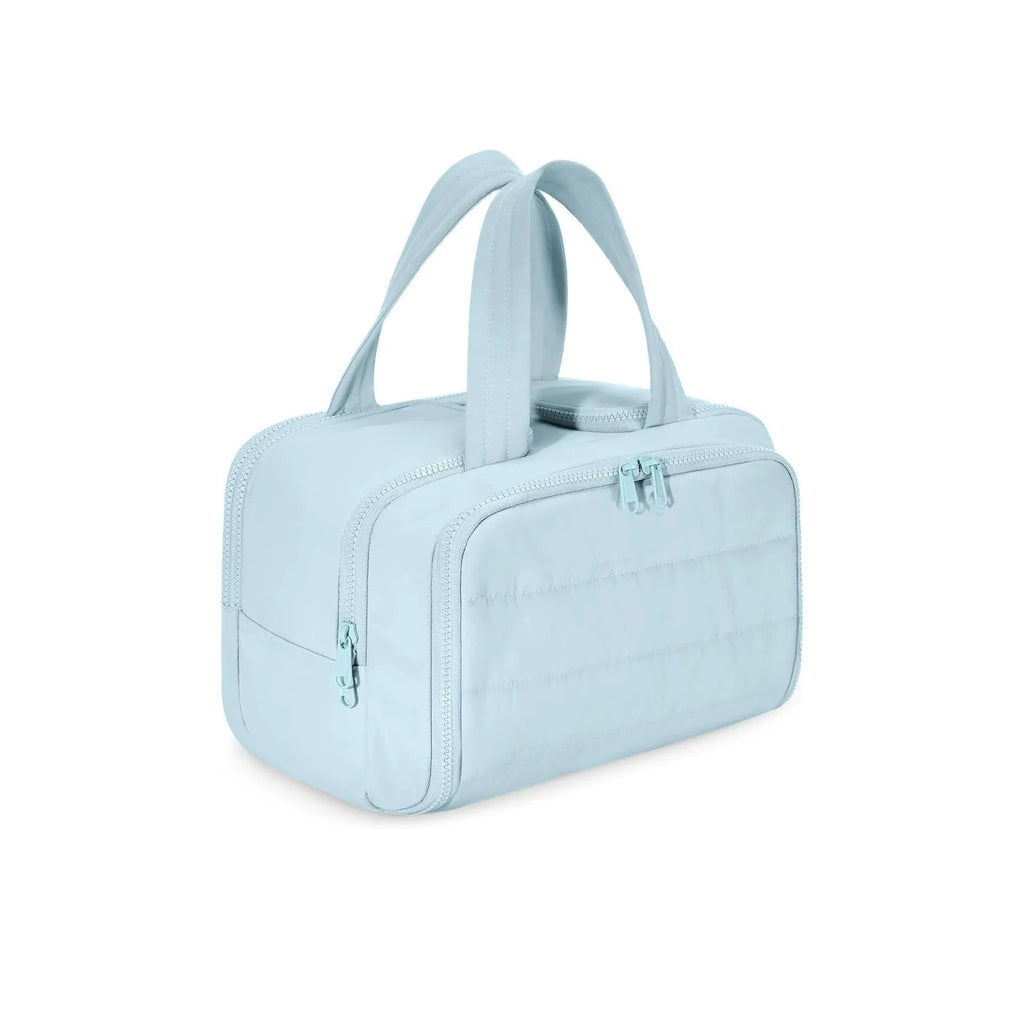 Large lightweight travel wash bag in pink with a wide-open zipper showing a fluffy interior lining.