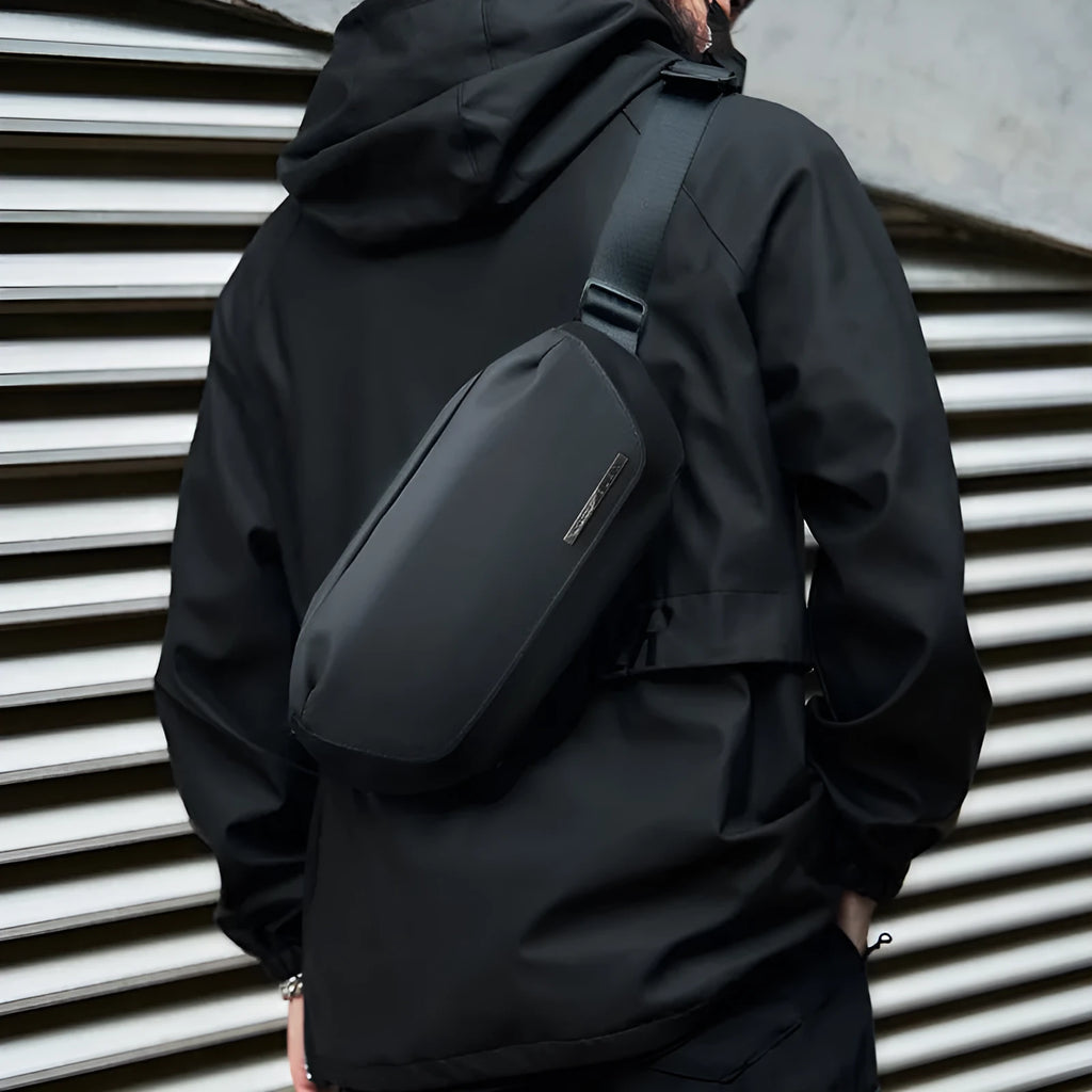 Black Oxford cloth men's crossbody messenger bag with a shoulder strap.