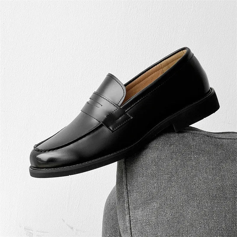Black men's slip-on derby leather shoes with a rubber sole on a white background