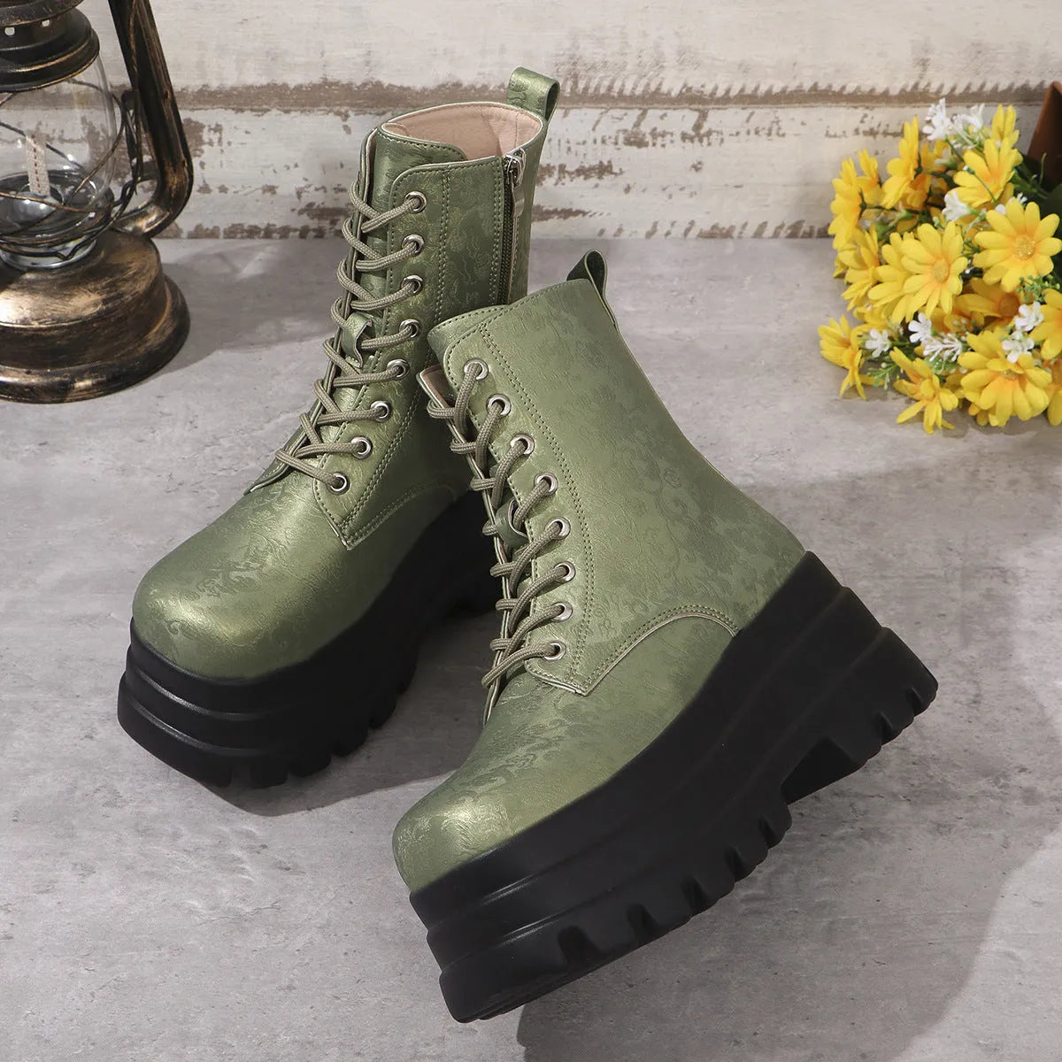Women's black platform Martin boots with side zip and chunky rubber sole.