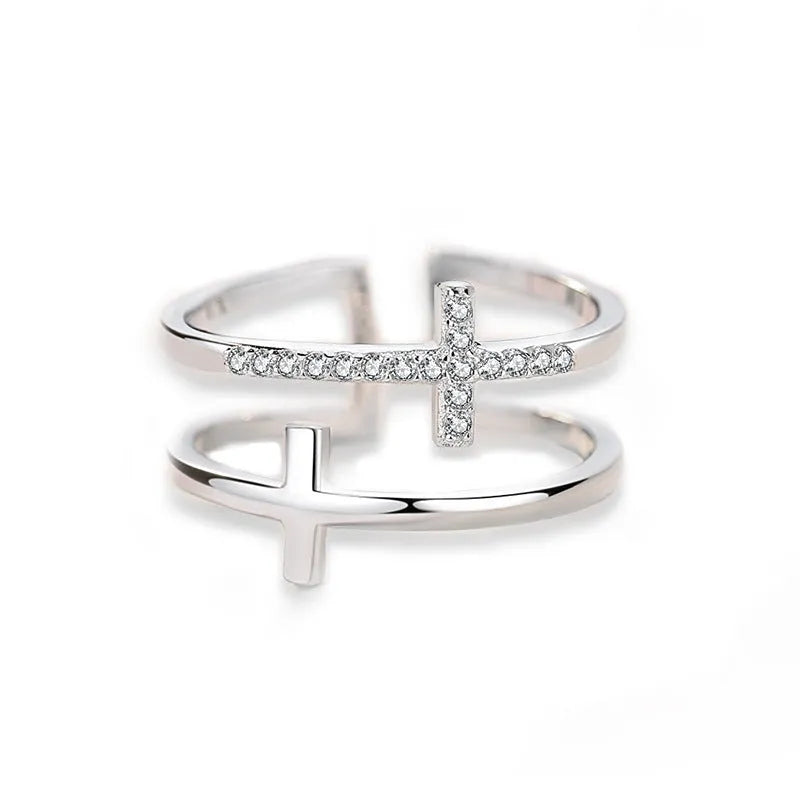 Adjustable double cross geometric ring in white gold colour with zircon stones in a sterling silver inlay.