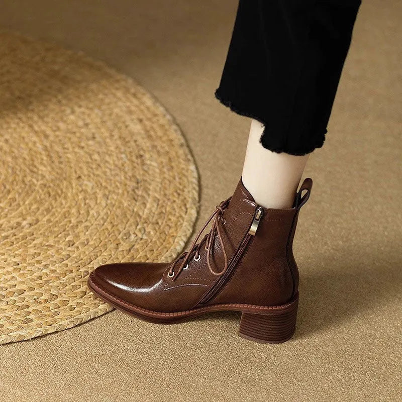 Black pointed-toe women's short tube ankle boots with a 5.5cm heel on a white background.