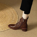 Black pointed-toe women's short tube ankle boots with a 5.5cm heel on a white background.