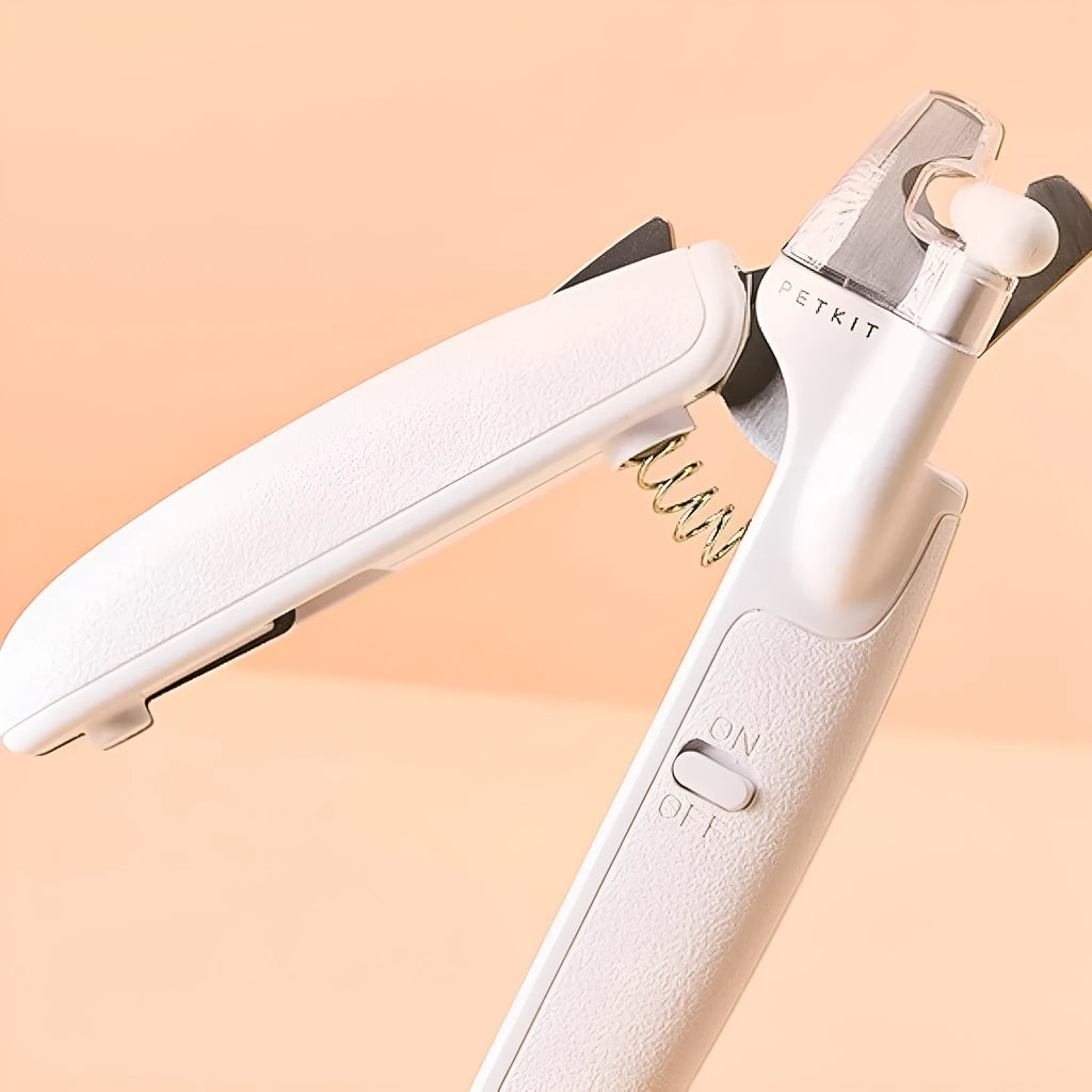 White pet nail clippers with LED light, transparent guard, triangular blades, and anti-slip handles for cat and dog grooming