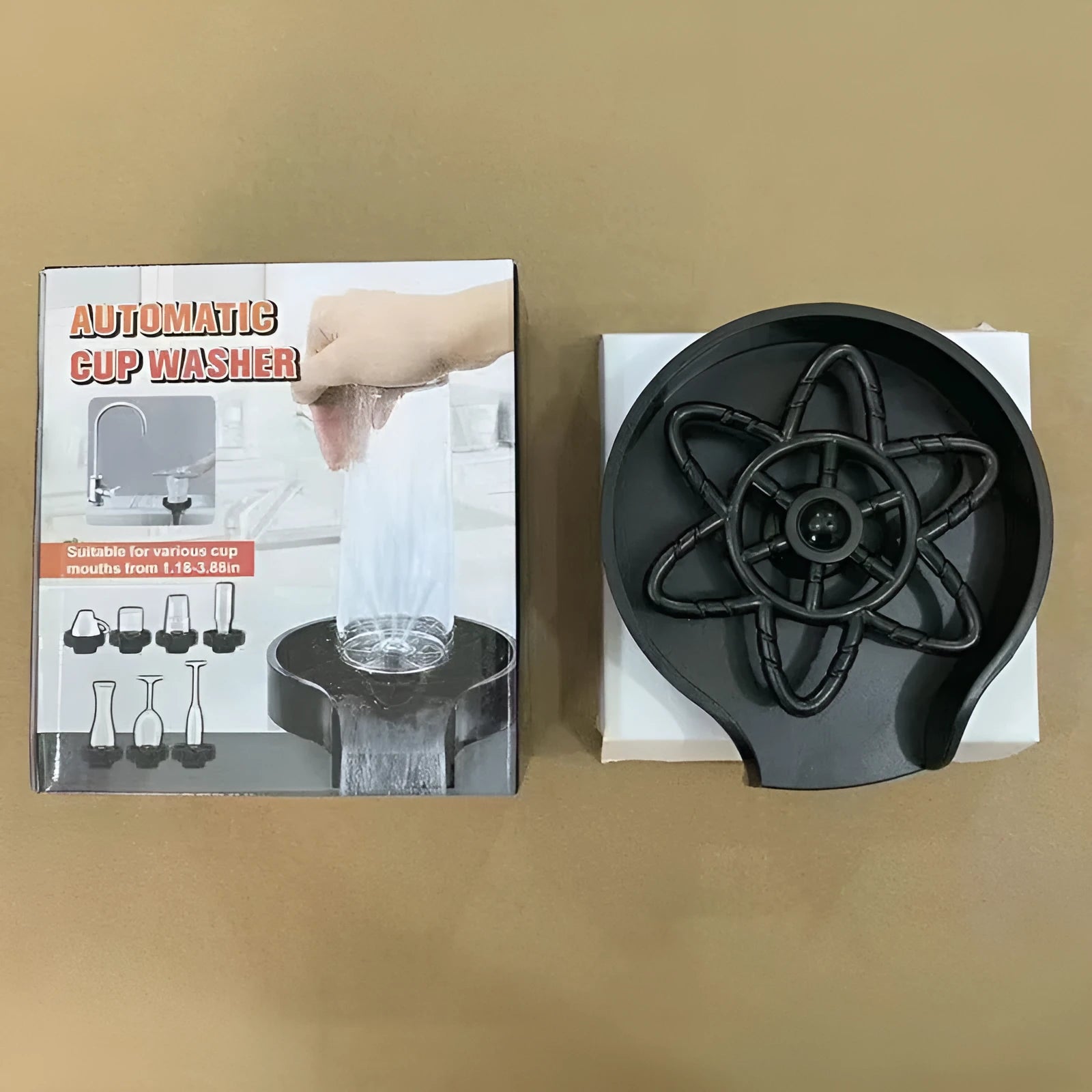 Black plastic household press type high pressure automatic cup washer on countertop