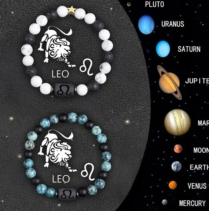 Set of twelve natural stone beaded bracelets with metal zodiac charms in an open gift box.