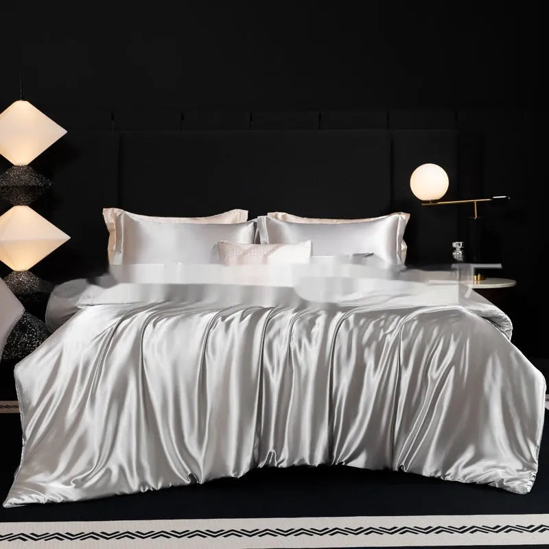 Solid colour silk bed sheet four-piece set showing Ash Purple, Cool Black, and Matcha Green options on a bed.