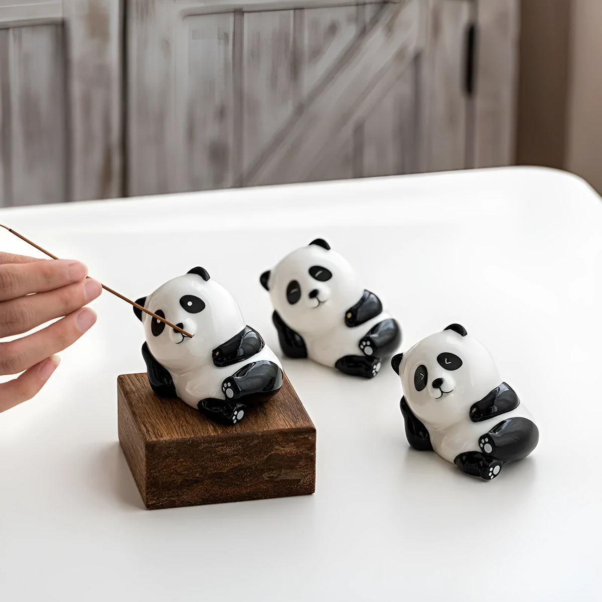 Ceramic panda incense holder with open eyes placed on a desk for aromatherapy use, 8.5cm long
