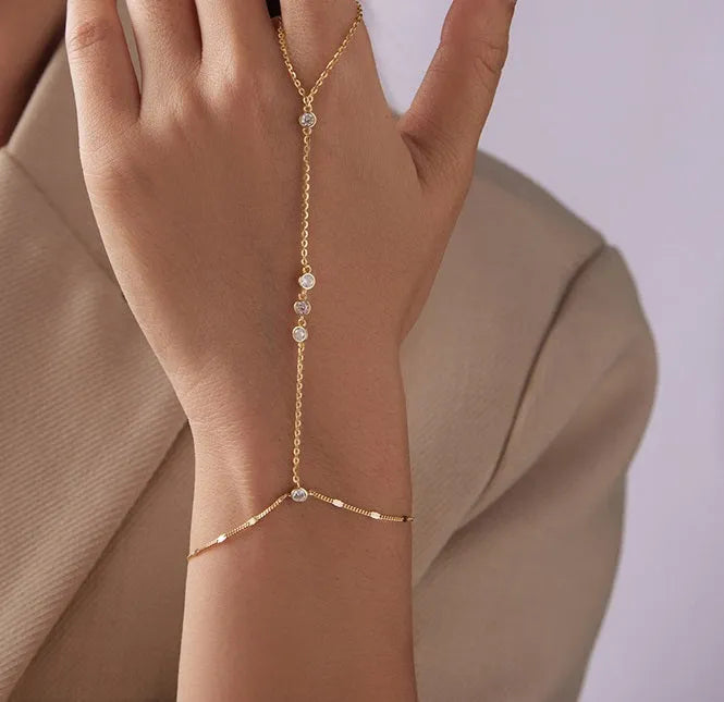 S925 sterling silver tassel bracelet with integrated ring and chain, shown in silver or gold electroplated finish