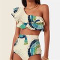 White one-shoulder swimsuit with a tiered, double-layer lotus leaf design skirt on a mannequin.