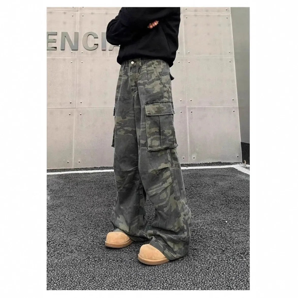 Vintage washed camouflage pattern cargo trousers with multiple pockets on a mid-waist fit.