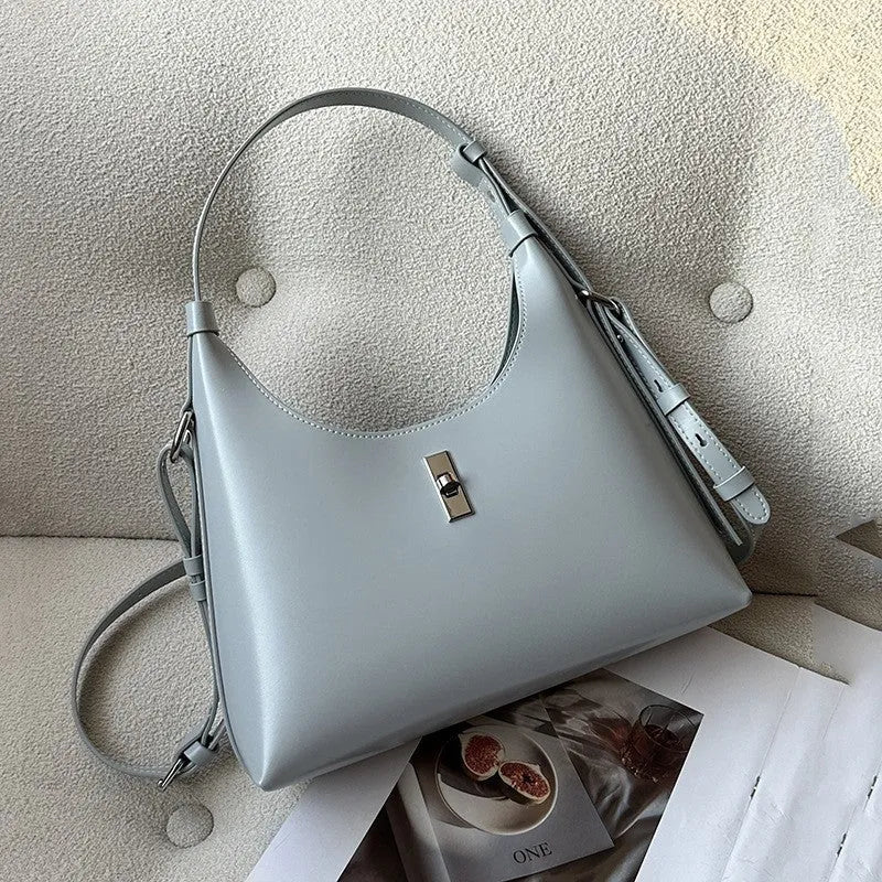 Soft genuine leather crossbody shoulder bag in a dumpling shape, shown in one of six available colours.
