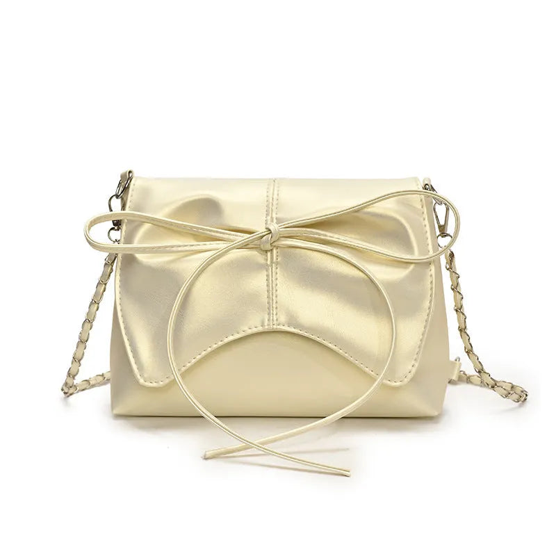 Women's black underarm crossbody bag with horizontal square shape and visible sewing details