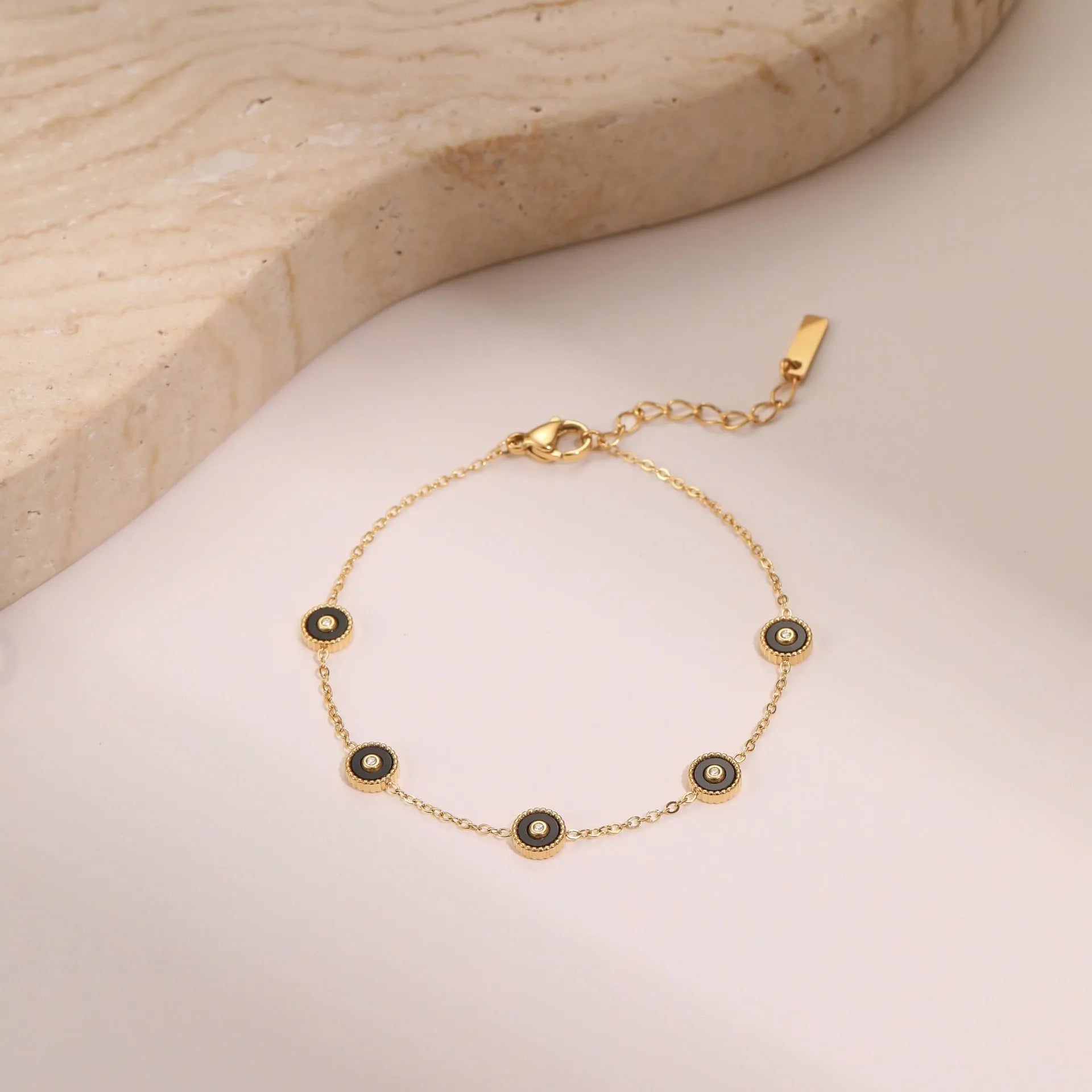 Geometric fritillary design bracelet and necklace set with 18K gold plating on stainless steel.