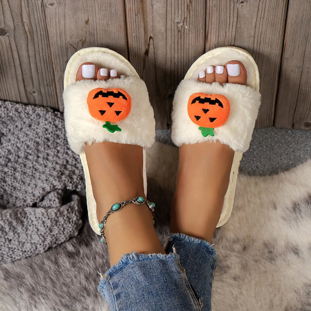Yellow cartoon pumpkin plush slippers with open toe and anti-slip sole on a white background.