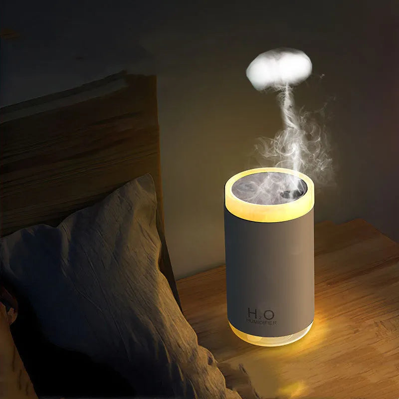 White jellyfish smoke ring humidifier with warm night light on a wooden surface