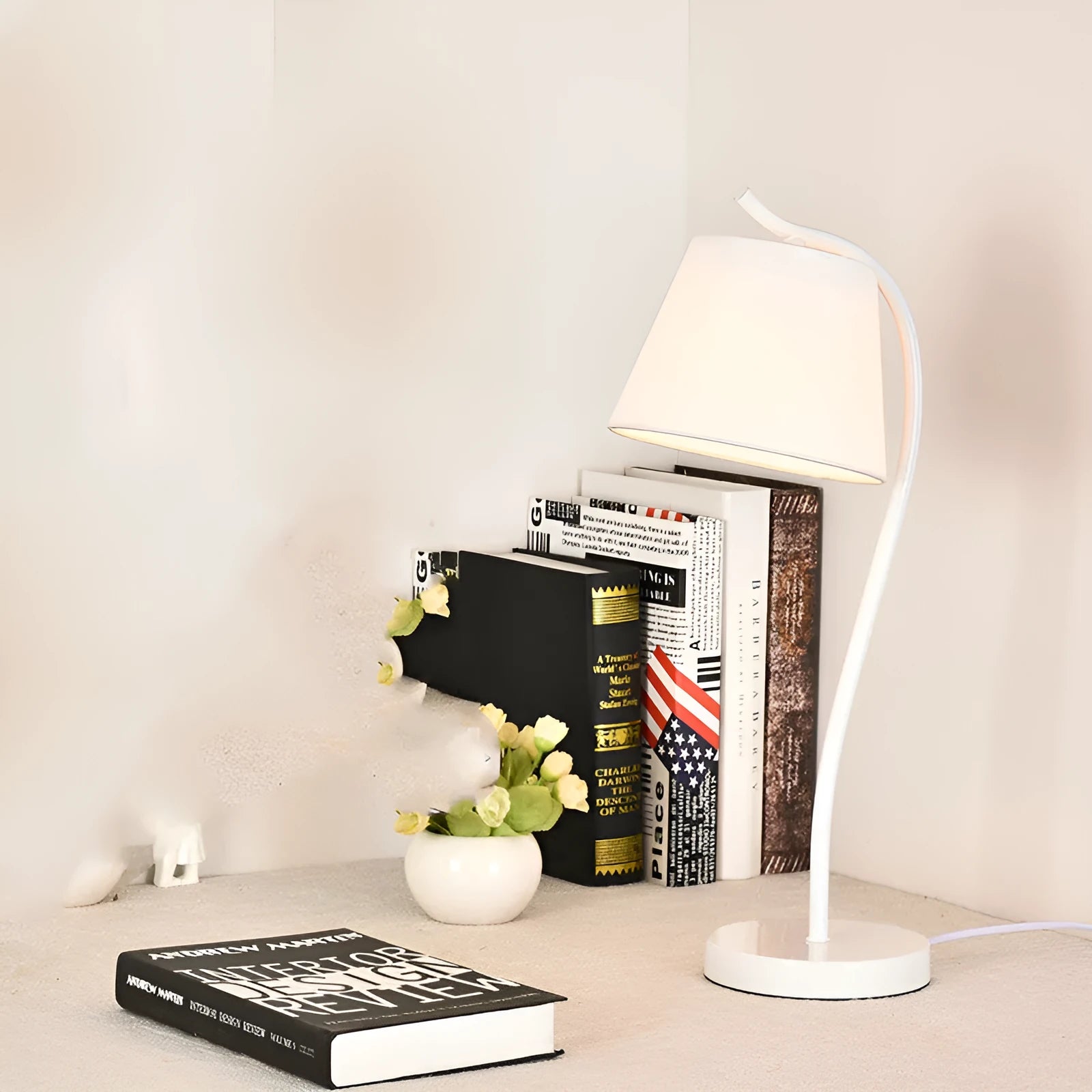 A modern LED table lamp with a push button dimmer switch on its base.