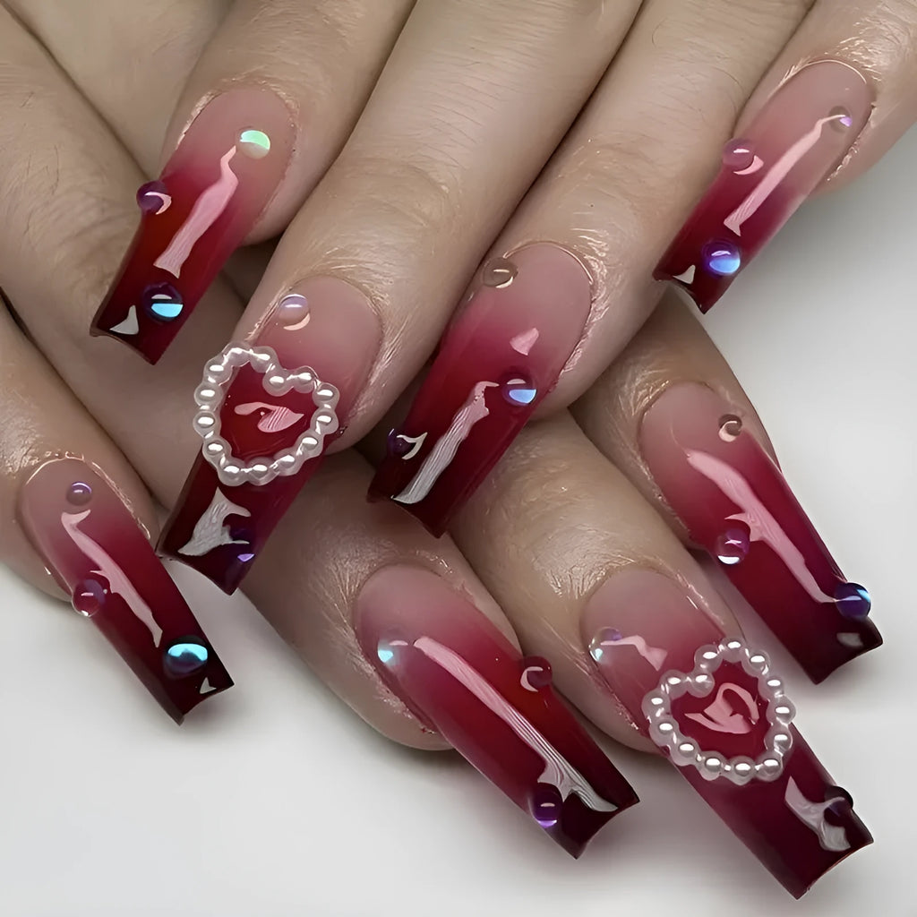 Wine red gradient fake nail tips with heart and plaid pattern, long ballet style, shown with jelly glue and rubbing cloth.