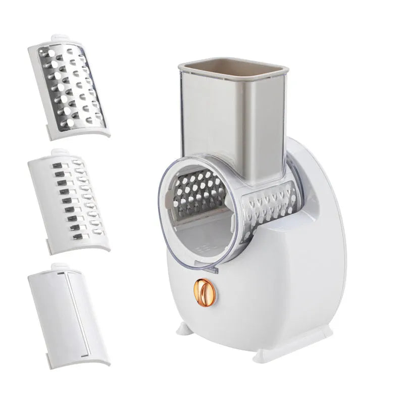White electric vegetable slicer with suction base and multiple blades on a kitchen counter.
