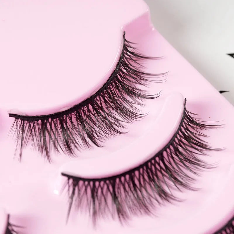 Pack of manga style false eyelashes showing natural wispy designs on plastic black terriers for cosplay and Korean makeup.