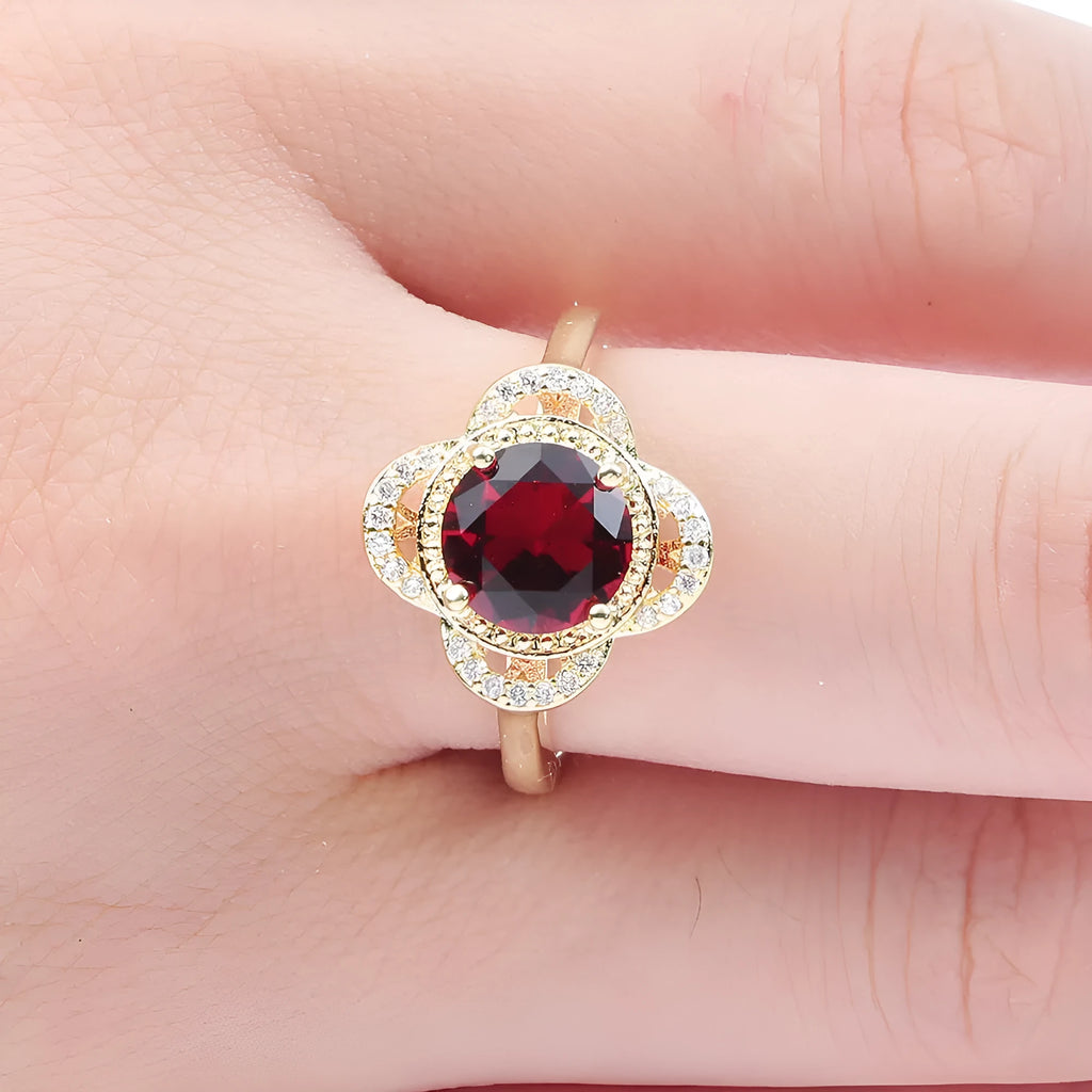 Copper ring with a fruit shape design and zircon stone inlays on a hand.