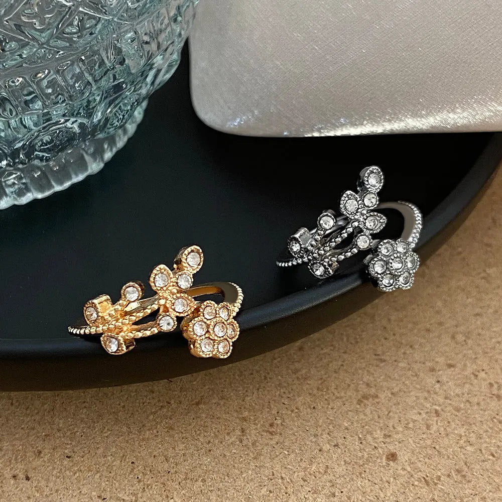 Open mouth floral ring with diamond-treated surface showing flower and leaf pattern in copper