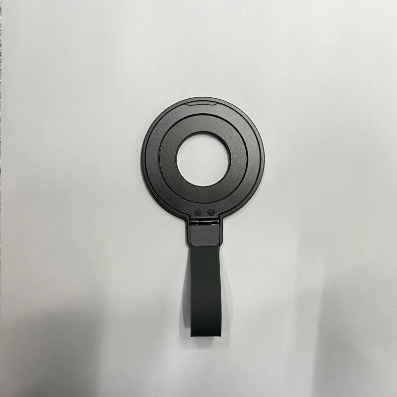 Portable magnetic wrist strap round silicone bracket phone holder in black on a wrist