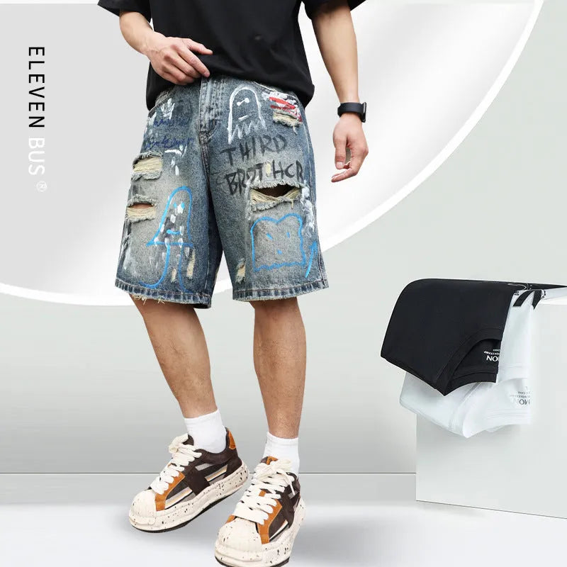 Blue denim shorts for men with rips and a graffiti pattern, featuring a zipper fly.