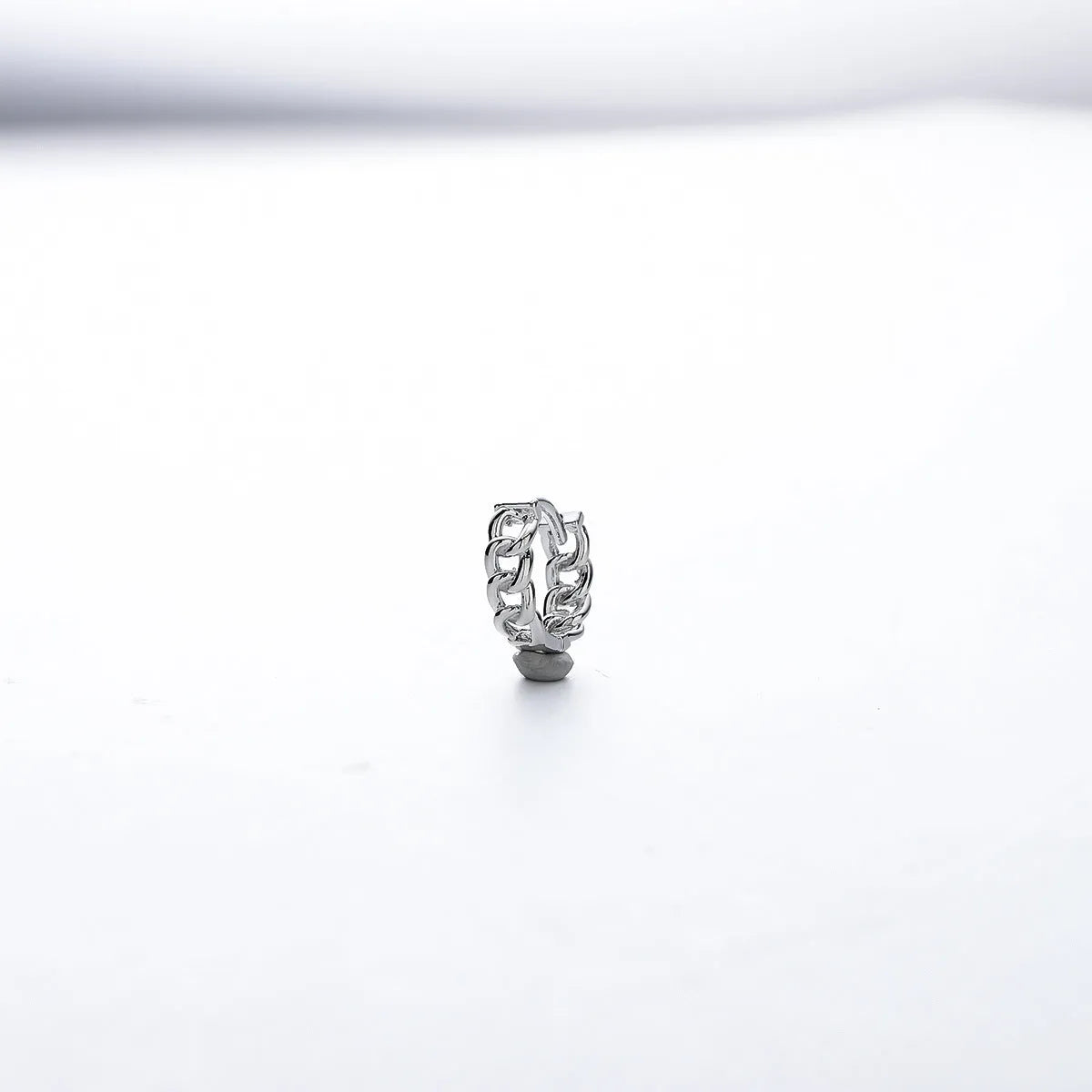 Men's geometric copper earring in silver, shown in single and pair configurations at 10mm and 14mm sizes.