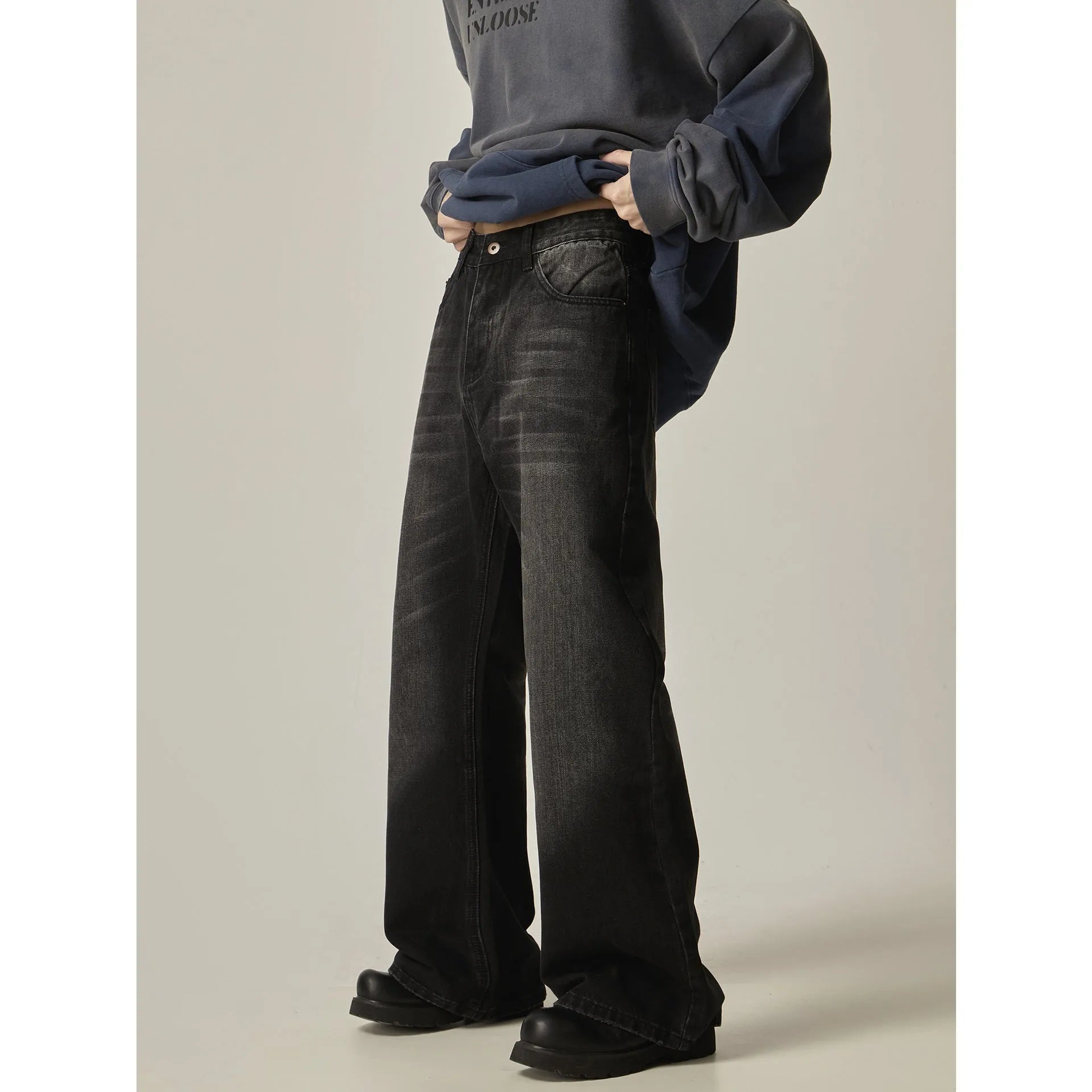 Black loose-fit straight-leg retro jeans with a zipper fly on a mannequin