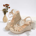 Women's beige fabric wedge sandals with fish mouth toe opening on wooden floor